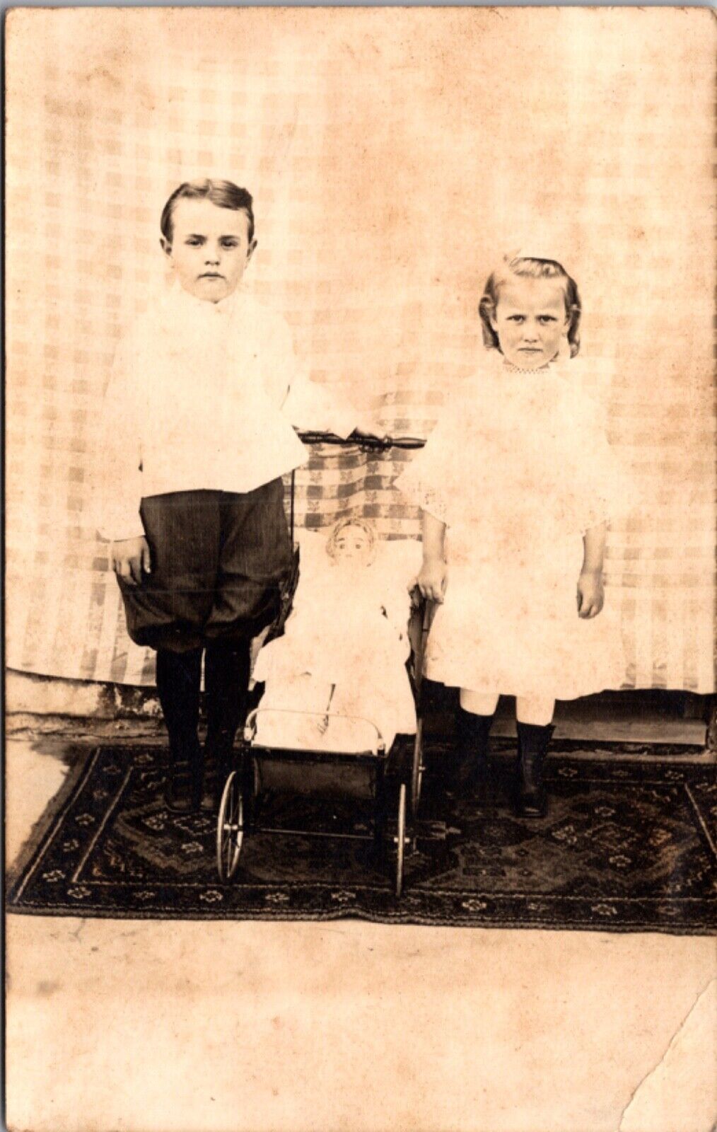 Real Photo Postcard Two Small Children with a Doll in a Stroller