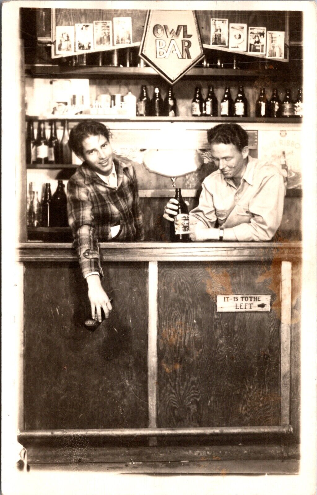 Real Photo Studio Postcard Two Men in Owl Bar Bottles of Alcohol