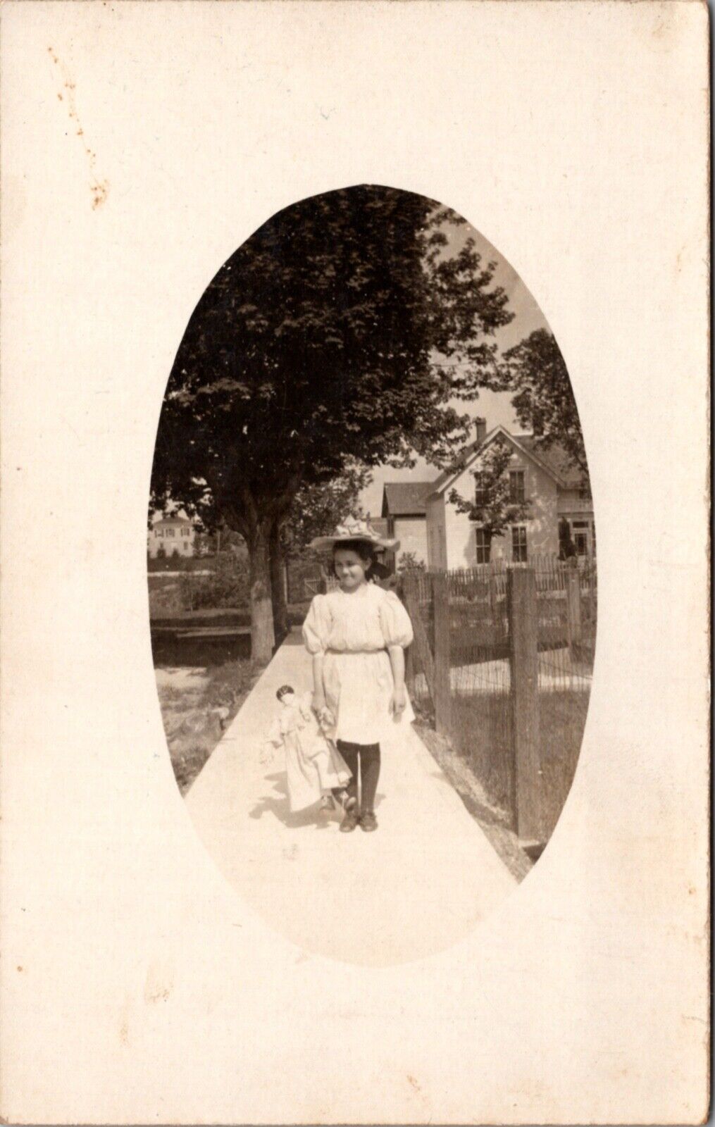 Real Photo Postcard Young Girl, Jessica Stevenson, on Sidewalk Carrying a Doll