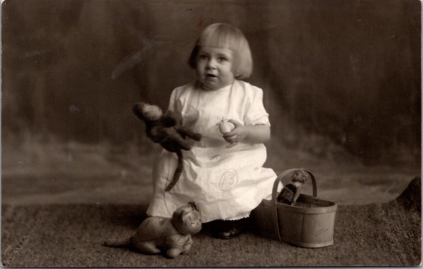 Real Photo Studio Postcard Little Girl 1 year 9 months old Doll Stuffed Animals