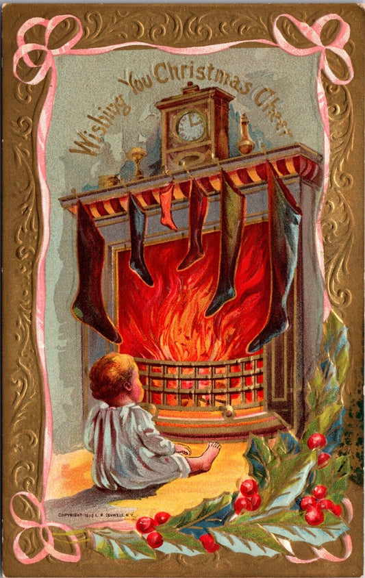 1910 Christmas Postcard Baby Sitting In Front of Fireplace Stockings Hung