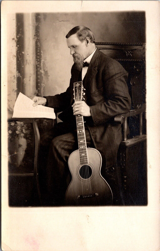 Real Photo Studio Postcard Well Dressed Man with Sheet Music and Guitar