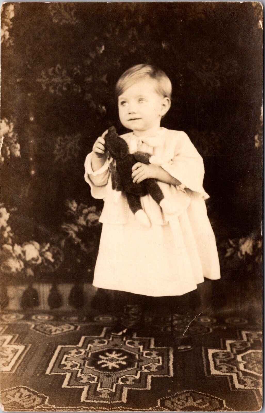 Real Photo Postcard Young Child Holding a Teddy Bear Outside~134632